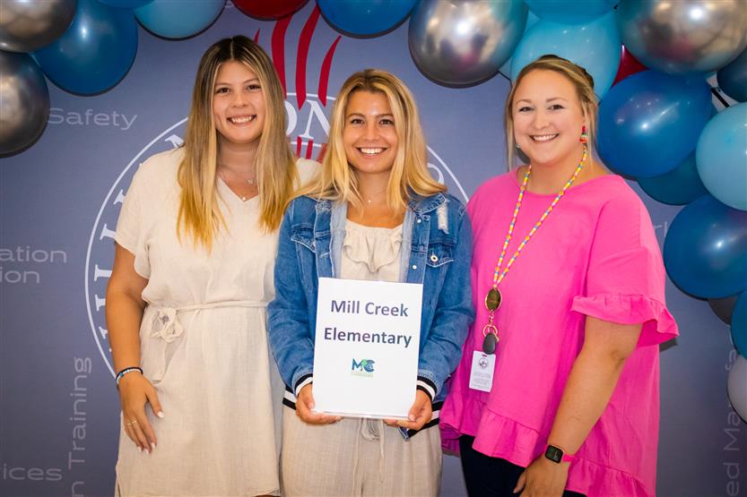 A group of teachers smile